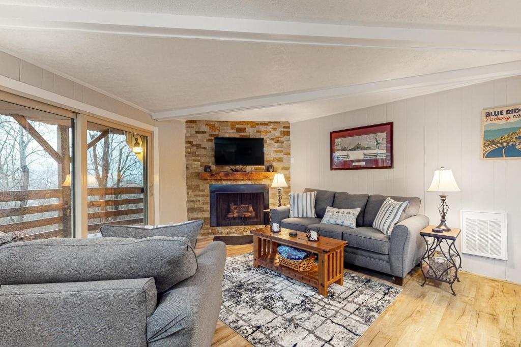 a living room with two couches and a fireplace at Timber Ridge C7 in Sugar Mountain