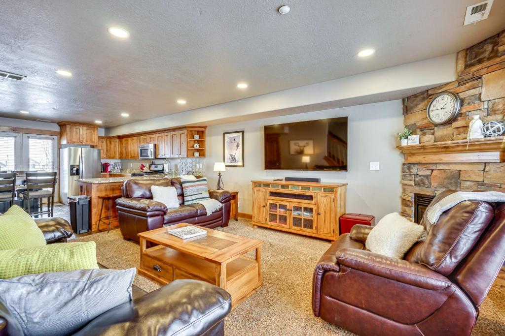 a large living room with leather furniture and a large tv at Eden Condo with Community Hot Tub, Close to Skiing in Eden