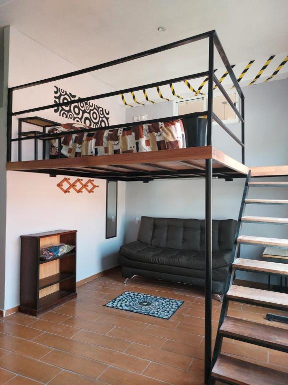 a living room with a loft bed and a couch at Harmony Loft in San Martín de las Pirámides