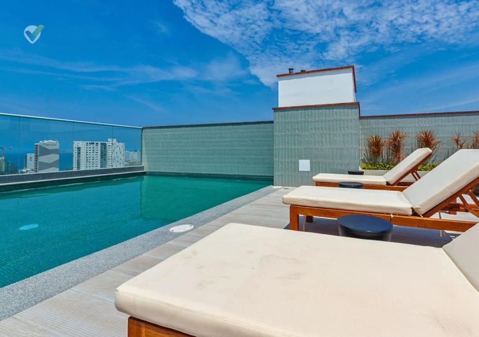 a swimming pool on the roof of a building at New Full Apartment in Barranco in Lima