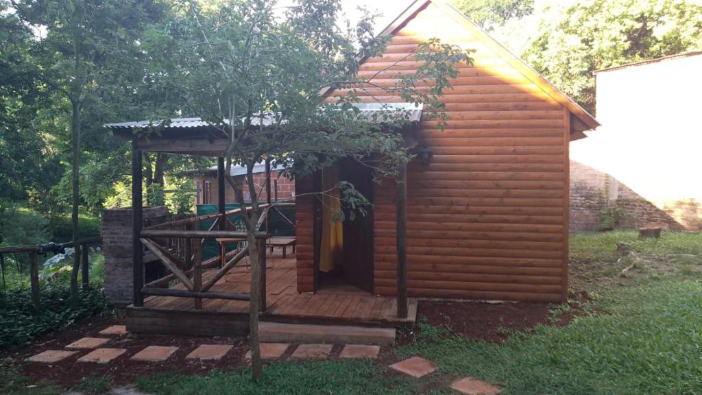 a small wooden cabin with a staircase leading to the door at Brisas in Jardín América