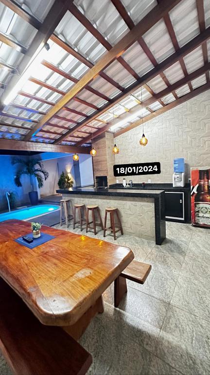 a large kitchen with a wooden table and chairs at Casa Siqueira Nova Viçosa in Nova Viçosa