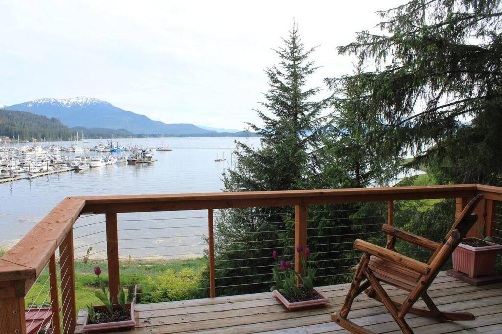 a deck with a bench and a view of a marina at Juneau Oceanfront Home Overlooking Auke Bay in Mendenhaven