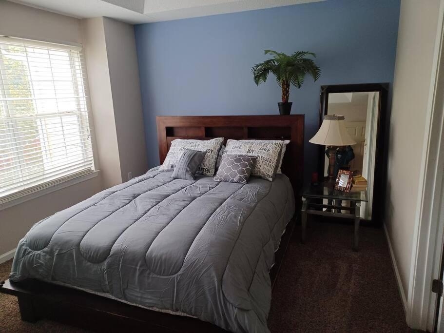a bedroom with a large bed and a mirror at Urban Adventure Townhome - Near Downtown Atlanta in Atlanta