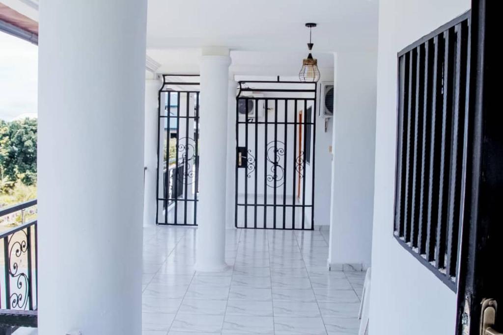 a hallway with two gates in a house at NANCY in Limbe