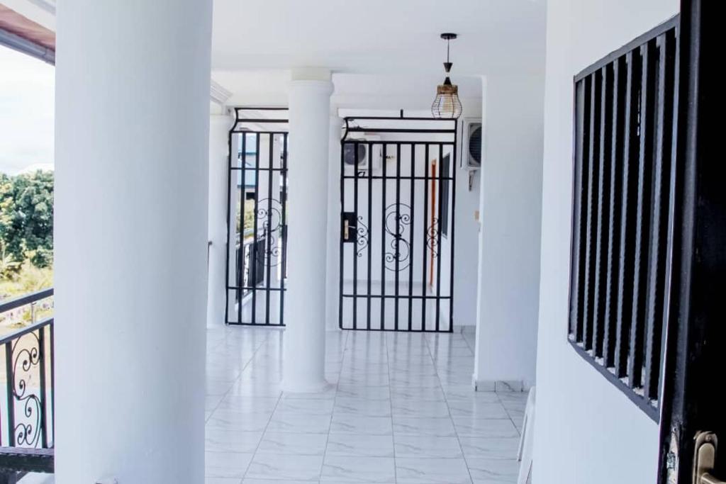 a hallway with two gates in a house at Nancy Real Estate in Limbe