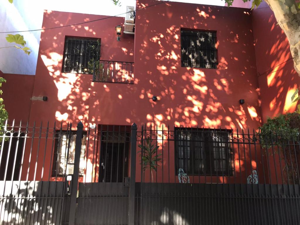 un edificio rojo con el sol brillando en él en Hermosa casita con jardín Goldas Haus en Florida