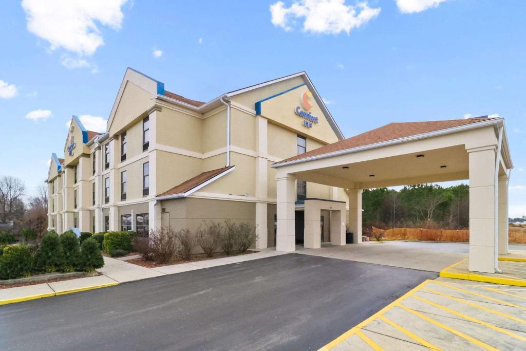 a rendering of the front of a hotel with a parking lot at Comfort Inn Dunn near I-95 in Dunn