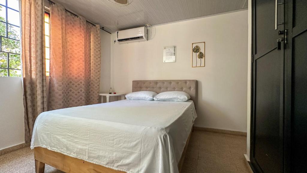 Postel nebo postele na pokoji v ubytování BOUTIQUE HOTEL BALOP Valledupar