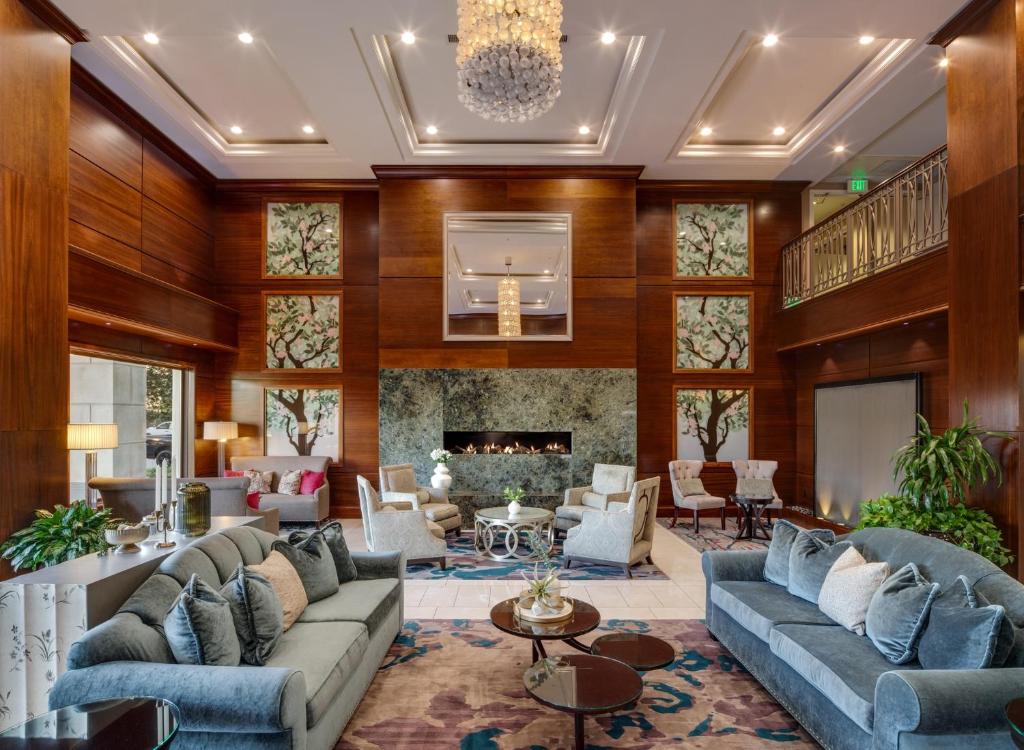 a living room with couches and a fireplace at Ayres Hotel Huntington Beach/Fountain Valley in Fountain Valley