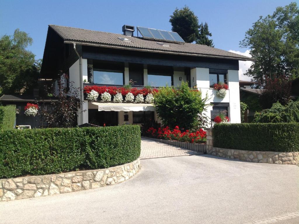 a house with flowers in the front of it at Rostohar Guest House in Bled
