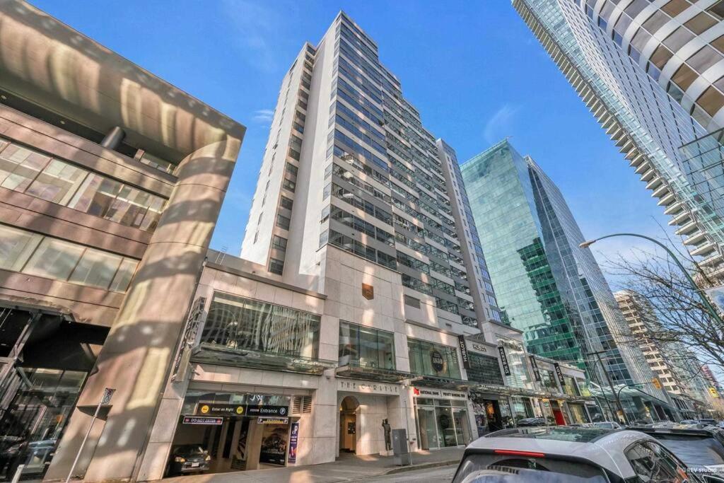 a large building in a city with tall buildings at Modern Condo in the Heart of DT Overlooking City in Vancouver