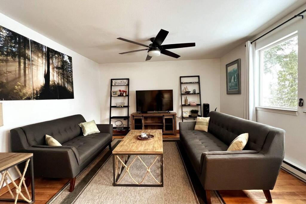 a living room with two couches and a ceiling fan at Ocean & Mountain View Home, near Downtown Juneau in Juneau