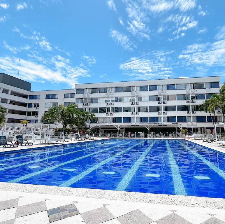 a large swimming pool in front of a building at Hotel del Llano in Villavicencio