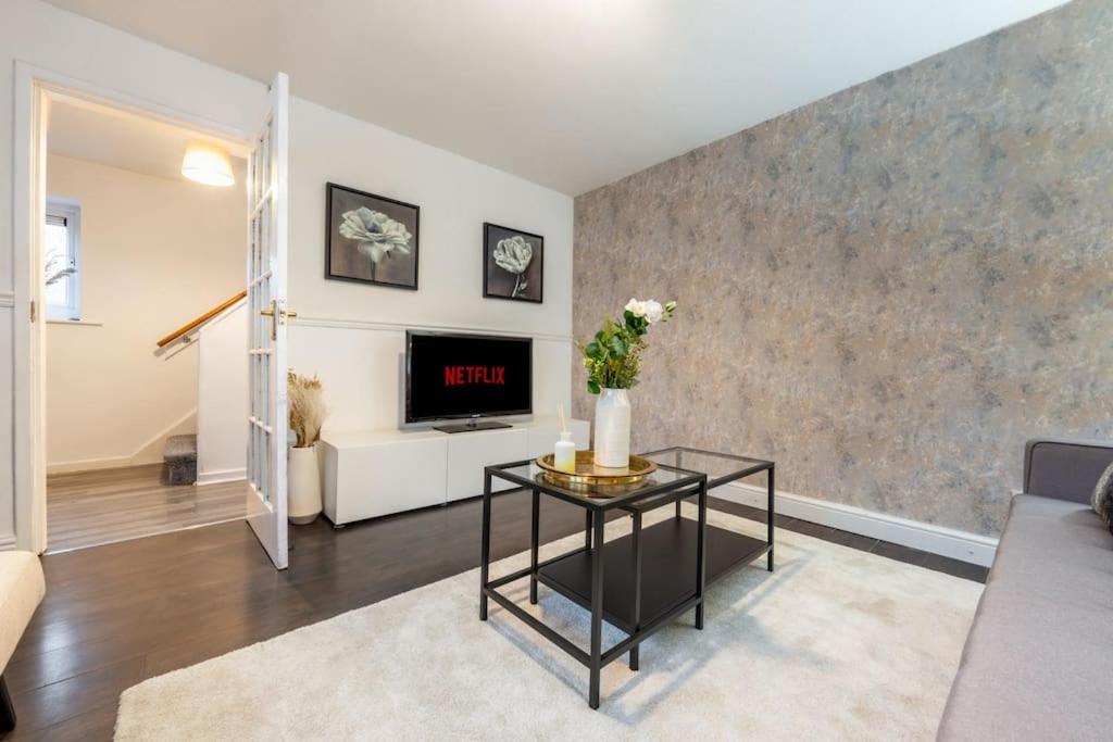 a living room with a couch and a table at Modern Wolverhampton 3 bed Home in Wolverhampton
