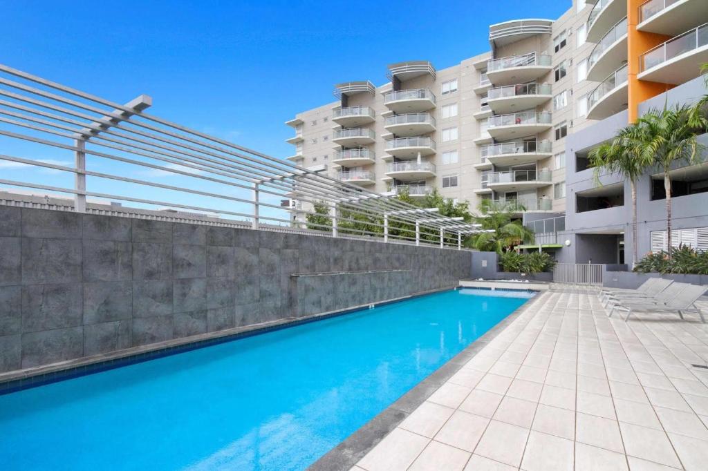 a swimming pool in front of a building at South bank Serviced Apartments in Brisbane