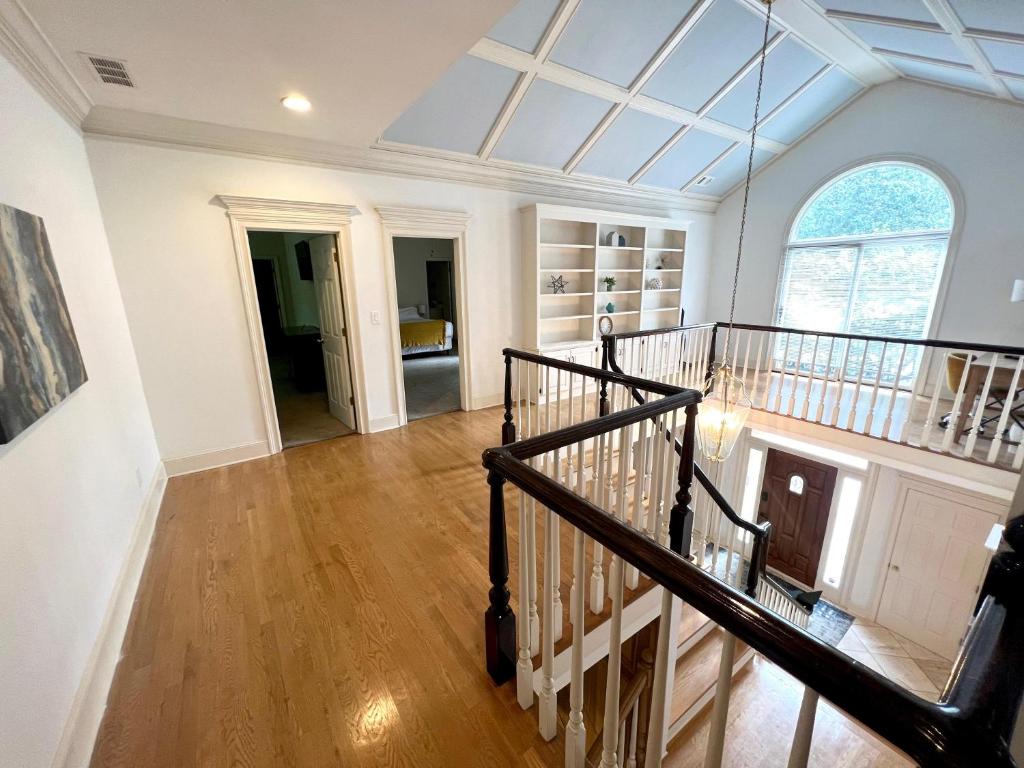 a large room with a staircase and a large window at 2811 Hawthorne Dr, NE Top Unit in Atlanta