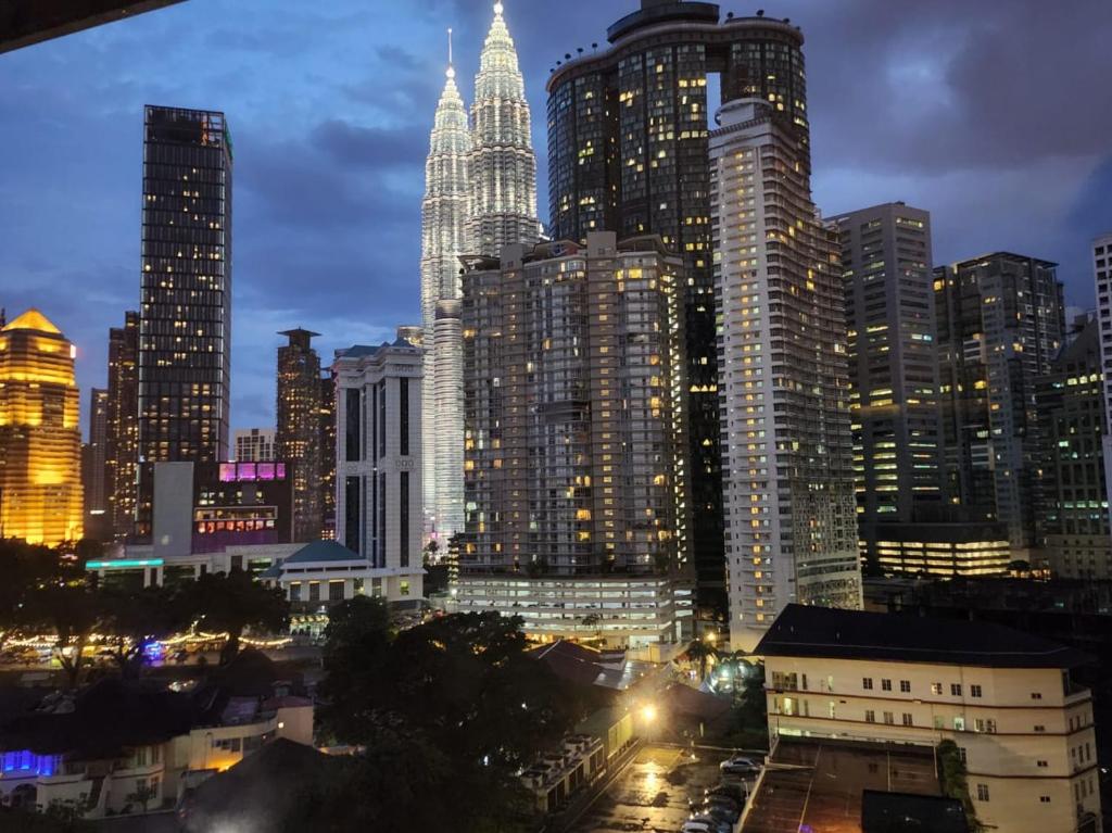 a city skyline with tall skyscrapers at night at Vortex Suites KLCC by Fortune in Kuala Lumpur