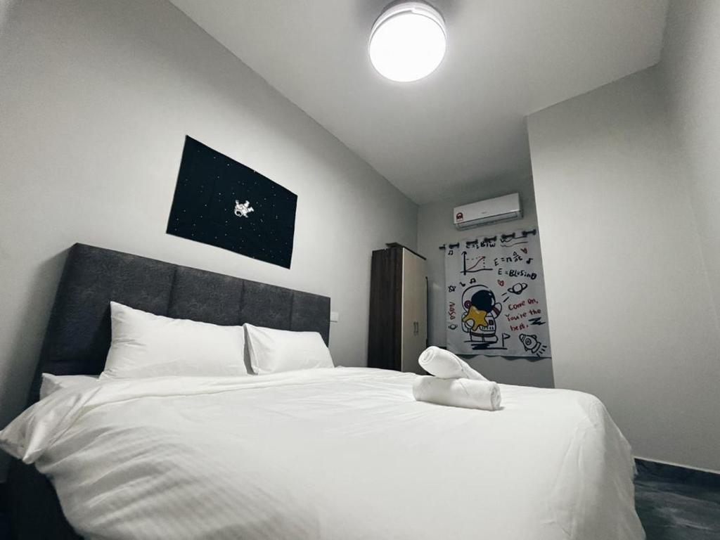 a bedroom with a large white bed with a black headboard at Room with PrivateBathroom, Projector, KSL Mall in Johor Bahru
