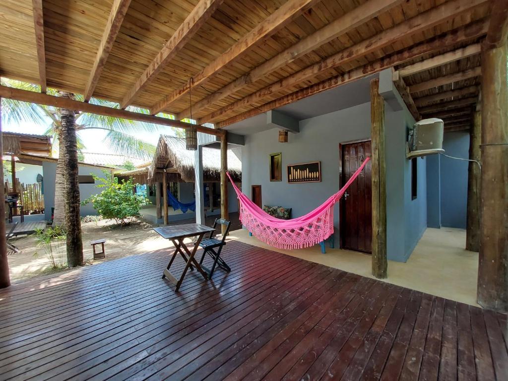a porch with a hammock and a tv on it at Taipu In House in Marau