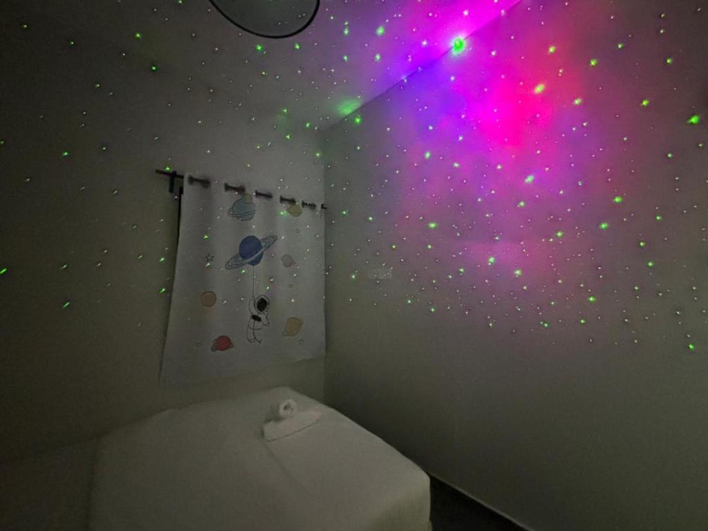 a bathroom with a wall with planets and a toilet at Room with Private Bathroom & Opposite KSL Mall in Johor Bahru
