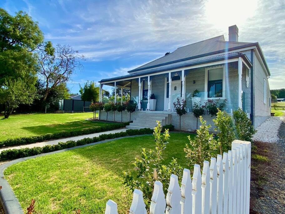 a white picket fence in front of a house at The Cottage at Seppeltsfield, Barossa Valley in Seppeltsfield
