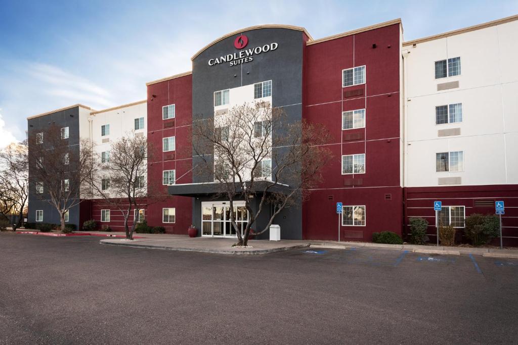 a red and white building with a sign on it at Candlewood Suites Roswell by IHG in Roswell