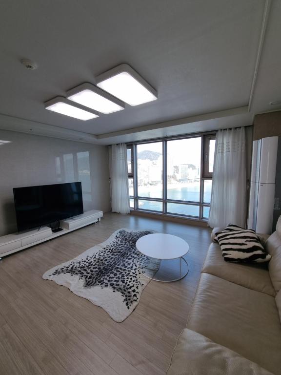 a living room with a couch and a table at Luxury ocean view in Busan
