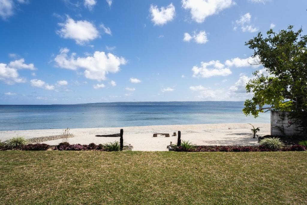 a view of a beach with the ocean in the background at Solwota Sands in Port Vila