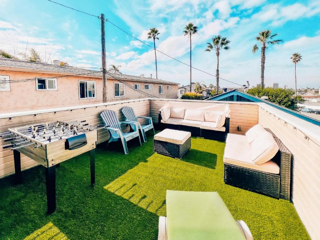 a patio with a table and chairs on a roof at Private Rooftop Oasis in North Park in San Diego