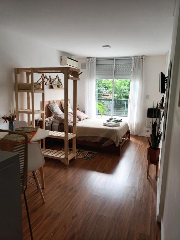 a bedroom with a bunk bed and a window at Mono Ov Lagos in Rosario