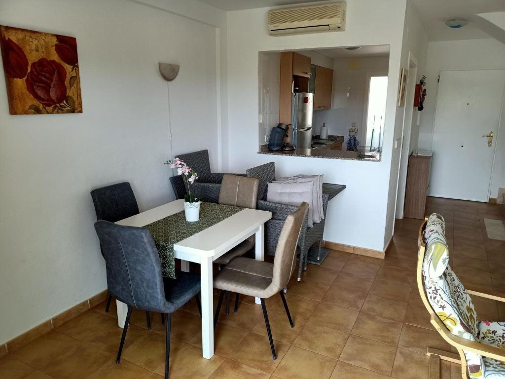 a dining room with a white table and chairs at Sunset Bungalow in Orihuela in Relleu