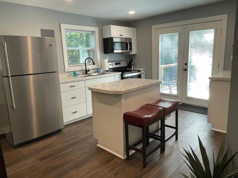 a kitchen with a stainless steel refrigerator and a counter at Cozy Home w/Deck & Fire Pit! in Greensboro