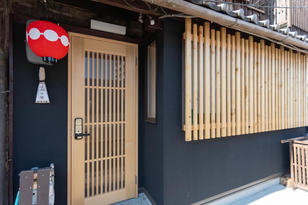 a room with a door and a ball on the wall at OneWorld Mibu壬生Luxury京町家 in Kyoto