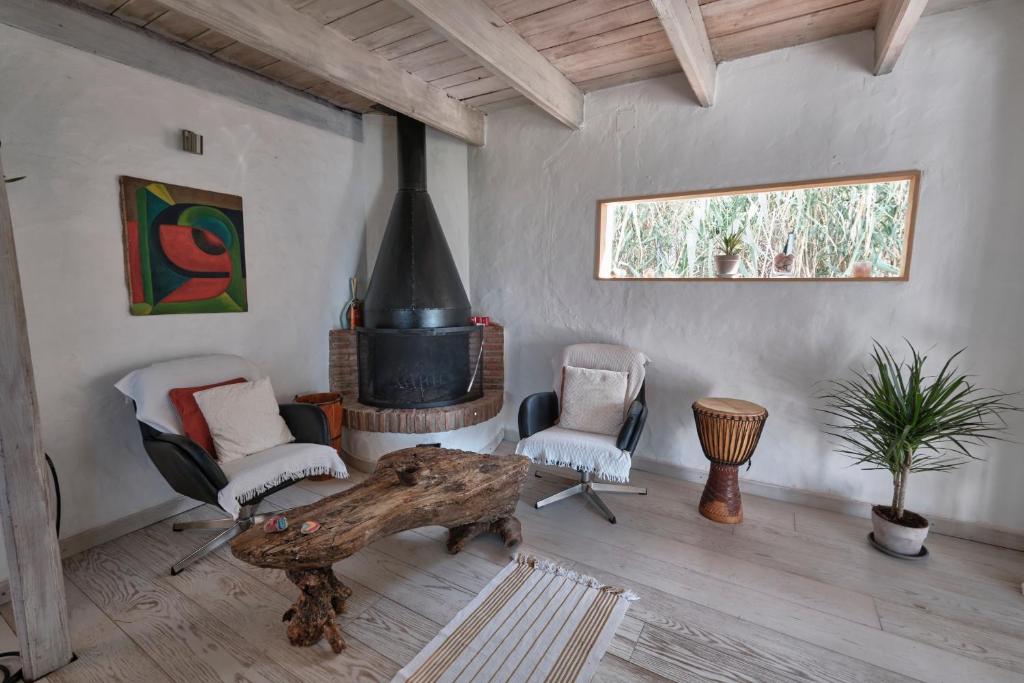 a living room with a table and a fireplace at Bolonia Beach Campus in Tarifa