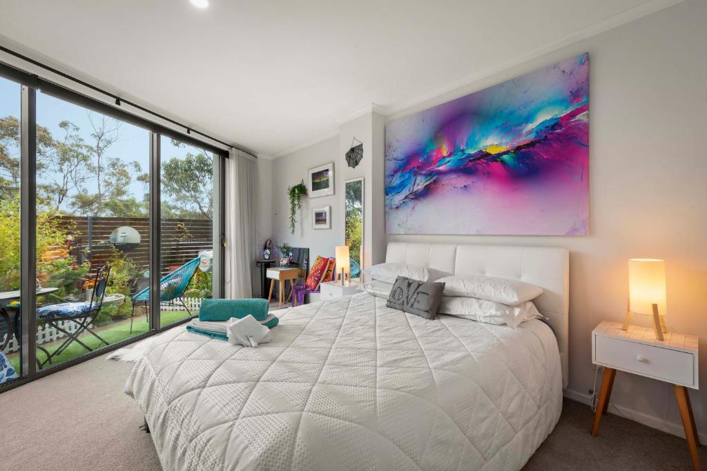 a bedroom with a large bed with a large painting on the wall at Nelson Apartment - 2 Bedroom 2 Bathroom in Sandy Bay