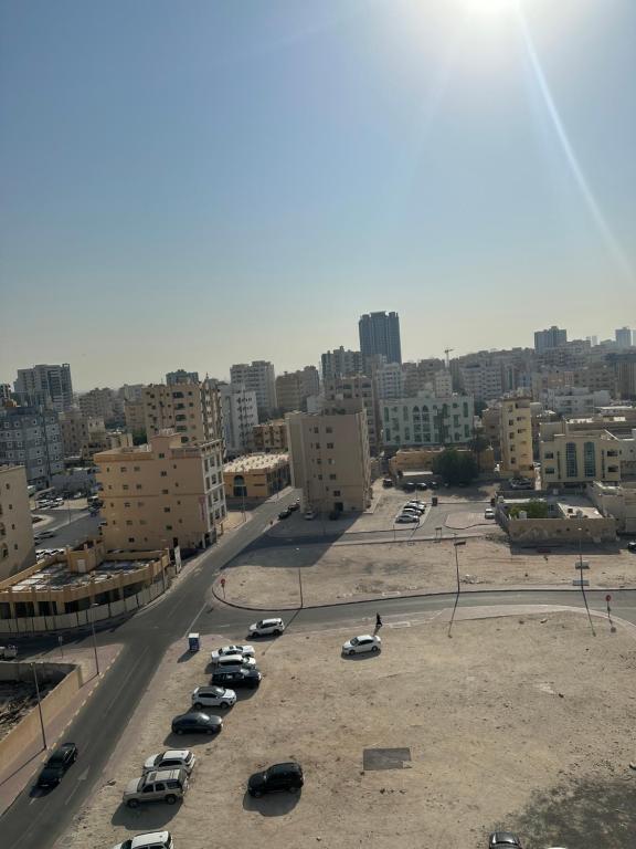 a city with cars parked in a parking lot at marena in Ajman 