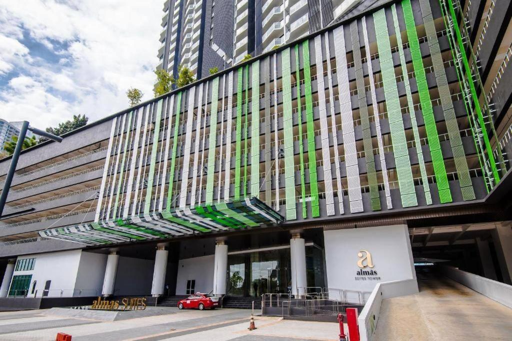 a building with a red car parked in front of it at Almas Suites Studio Netflix Puteri Harbour By STAY in Nusajaya