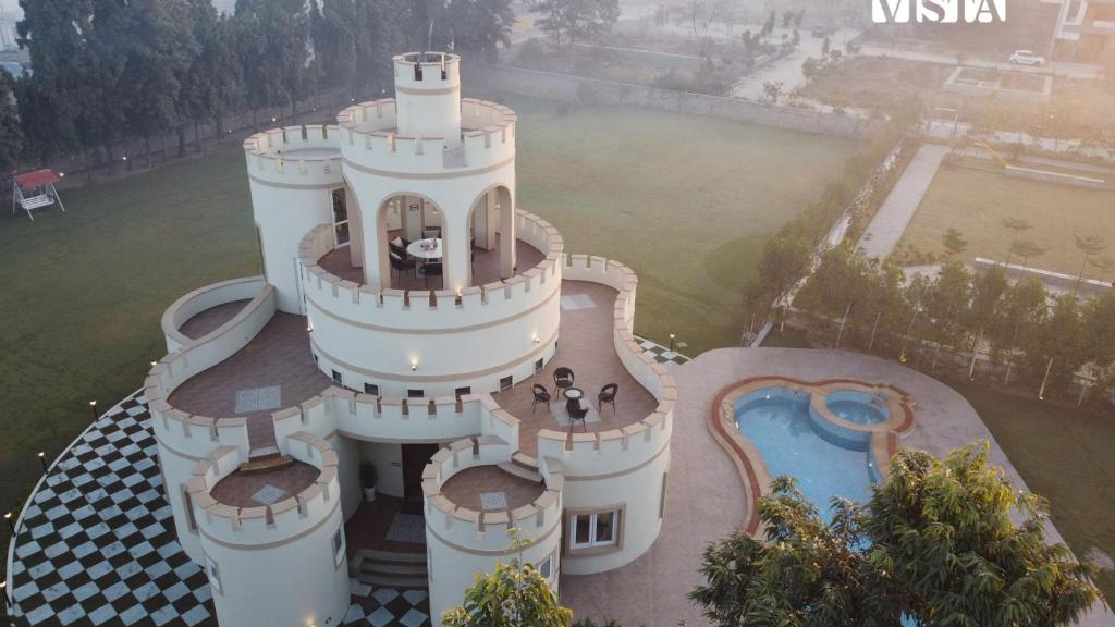 an aerial view of a resort with a swimming pool at StayVista's Mystic Castle with Terrace, Swimming Pool, Lawn with Gazebo in Jaipur
