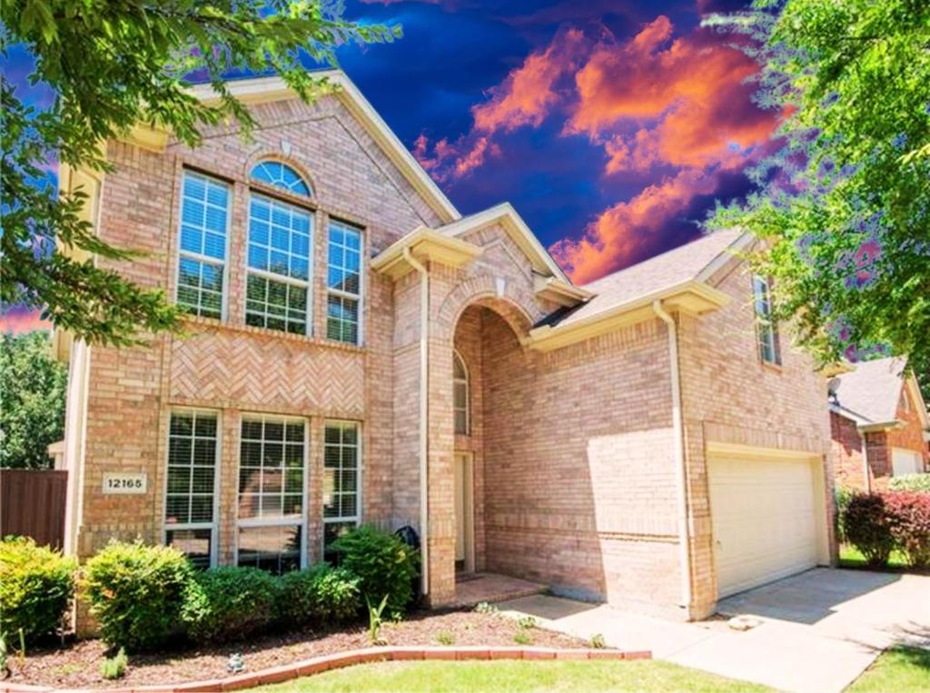a large brick house with a garage at Feel Home at Frisco in Frisco