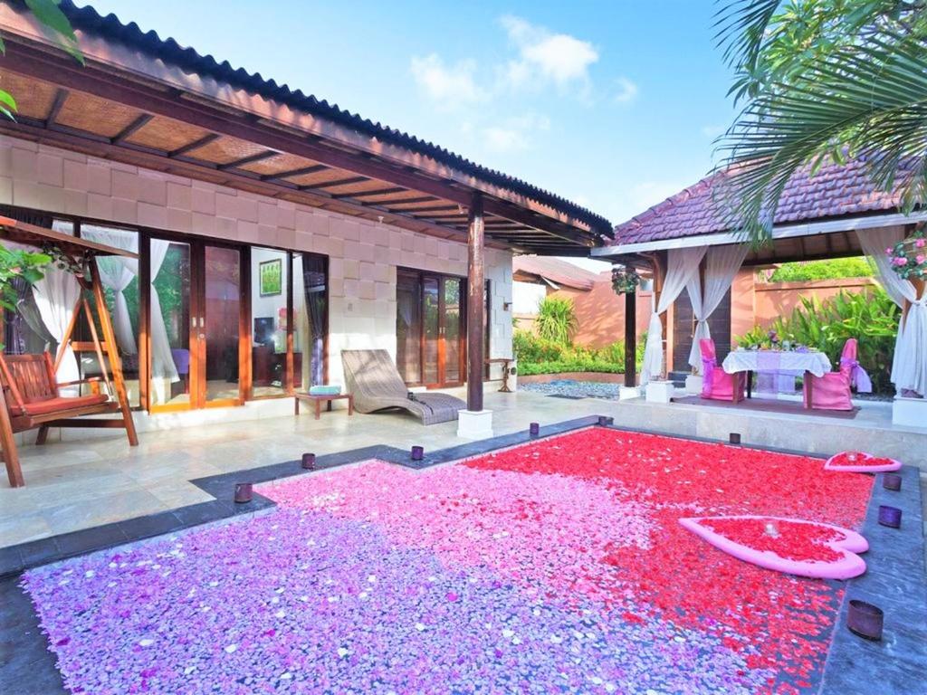 a patio with a large pile of pink gravel at One Bedroom Private Villa Kuta in Seminyak