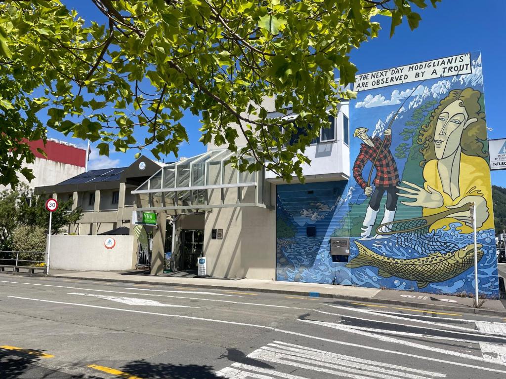 a mural on the side of a building on a street at YHA Nelson in Nelson