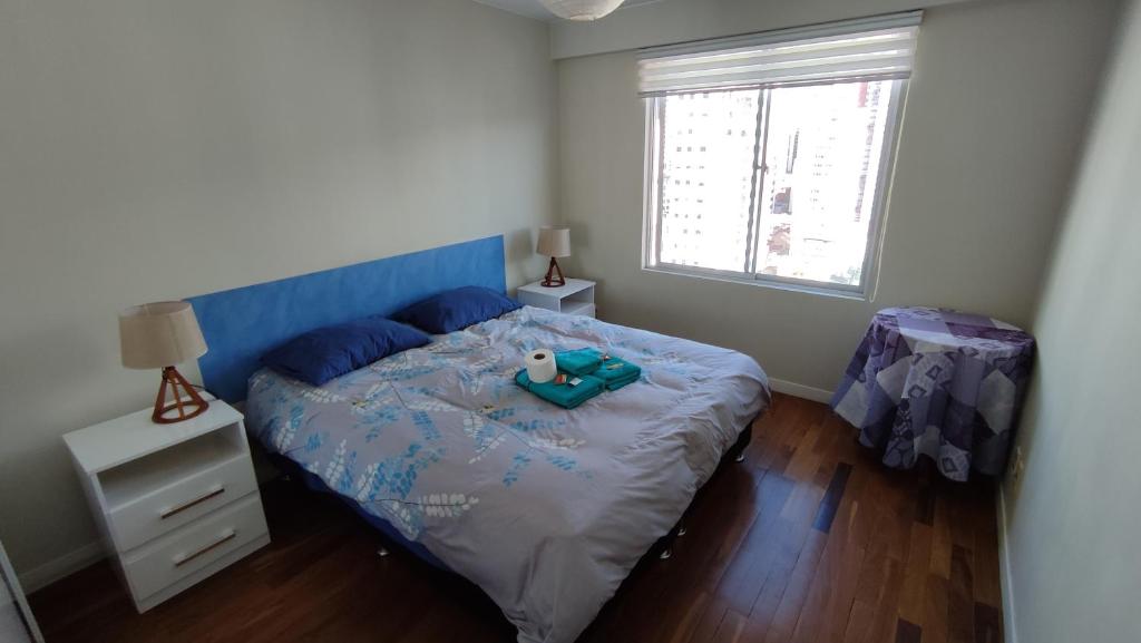 a bedroom with a bed with a teddy bear on it at Sopocachi BnB - Chic Apartment in La Paz