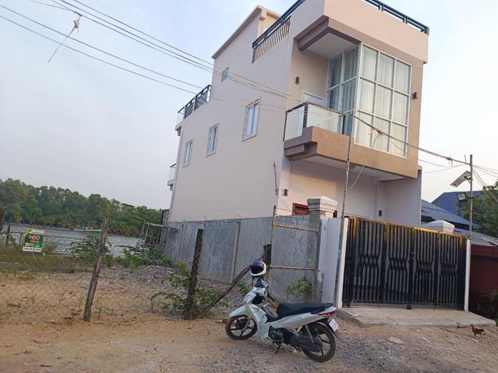 a motorcycle parked in front of a house at NM Homestay in Kampot