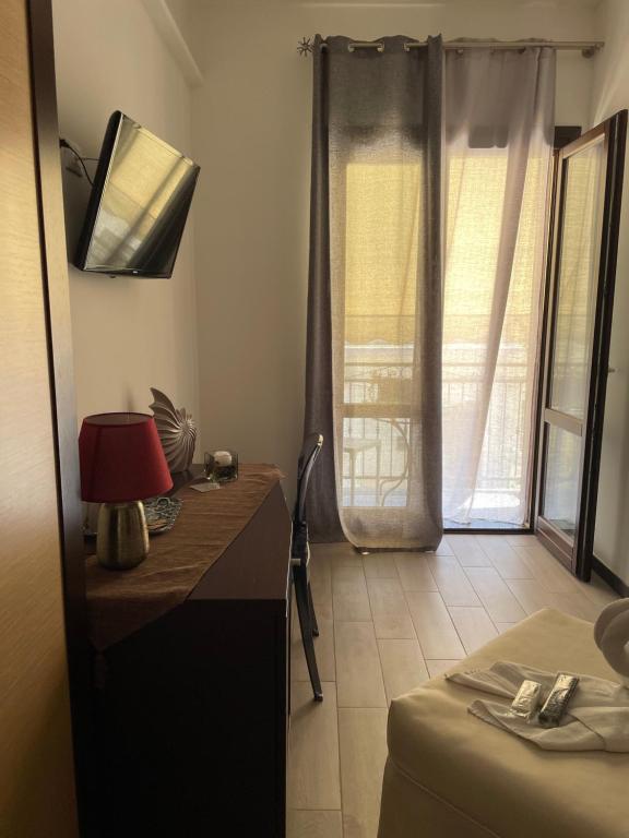 a room with a desk and a bed and a window at Sweet Dreams in San Vito lo Capo