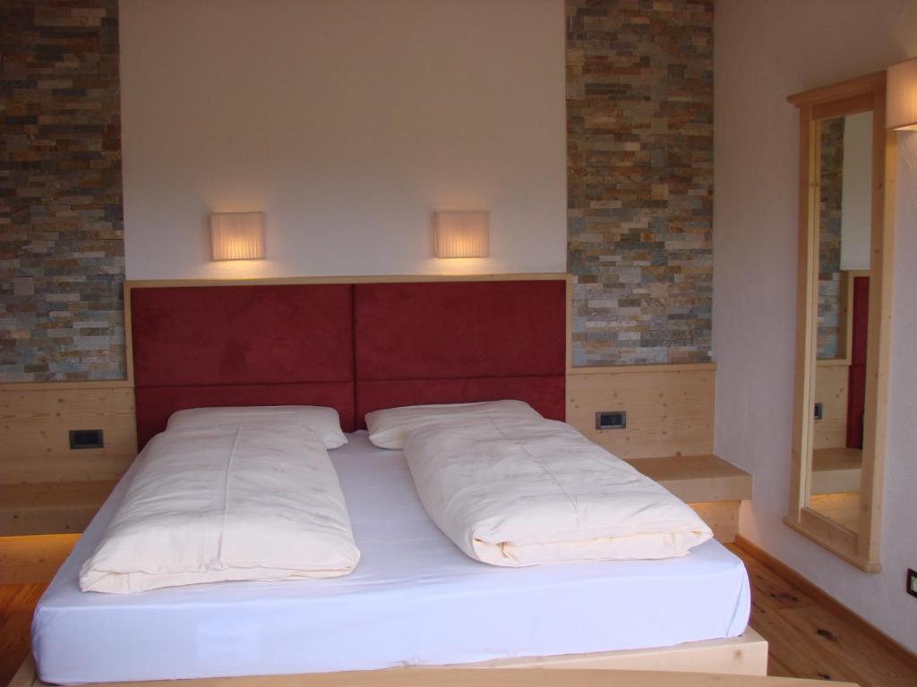 Postel nebo postele na pokoji v ubytování Hotel Pütia