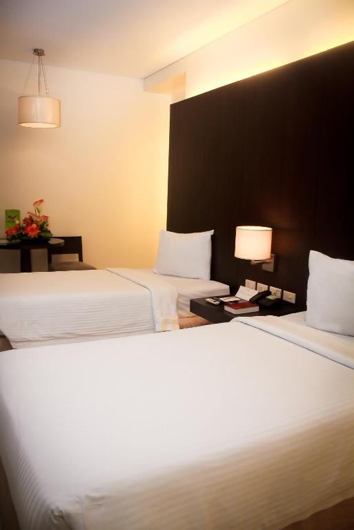 Postel nebo postele na pokoji v ubytování CityState Tower Hotel