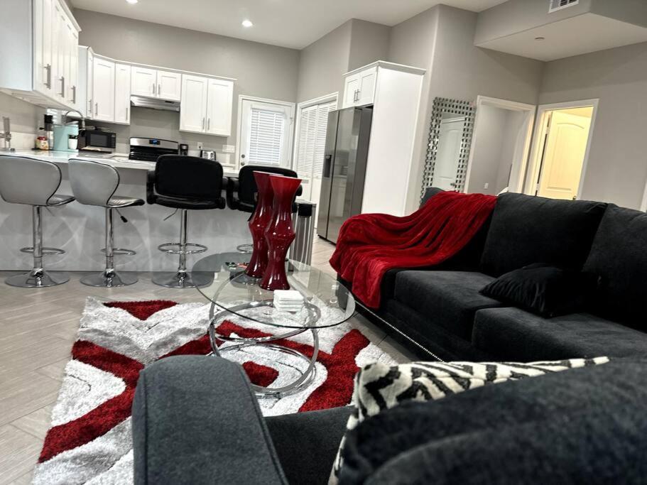 a living room with a couch and a kitchen at Just Built! Brand New! Insta-Worth Private! Luxurious Home! in San Bernardino