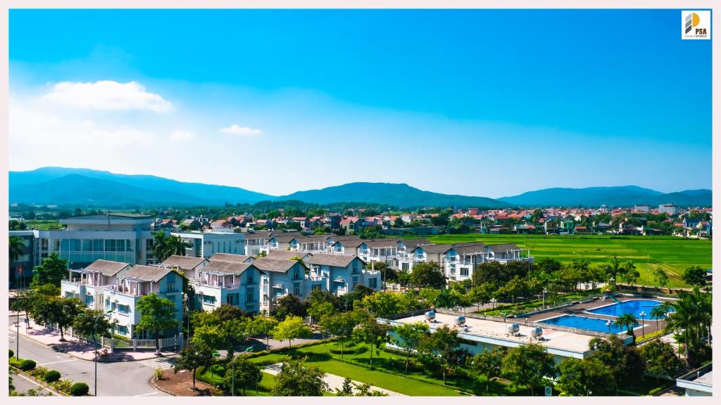 an aerial view of a resort with mountains in the background at PSA Nghi Sơn Condotel in Thanh Hóa