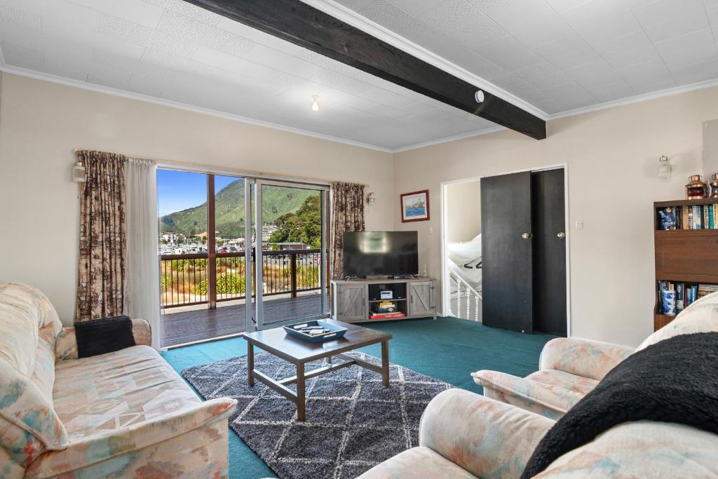 a living room with two couches and a tv at Coastal Charm - Picton Holiday Home in Picton